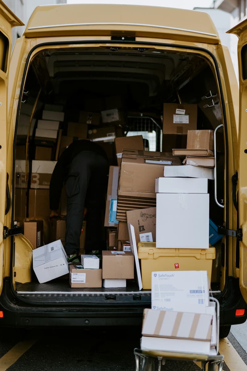 Mover loading packed boxes into the back of a van